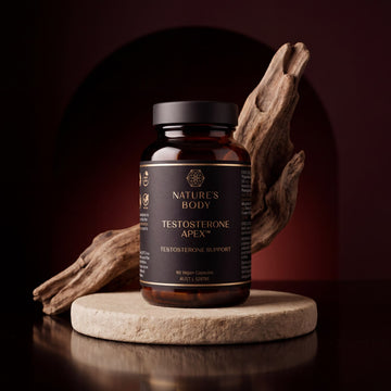 Nature’s Body Testosterone Apex bottle, 60 vegan capsules, AUST L 528761, on a timber block with driftwood and a stone arch.